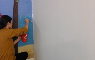 TUI volunteers touching up painting