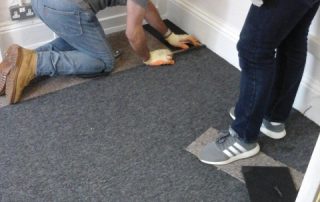 TUI volunteers measuring carpet